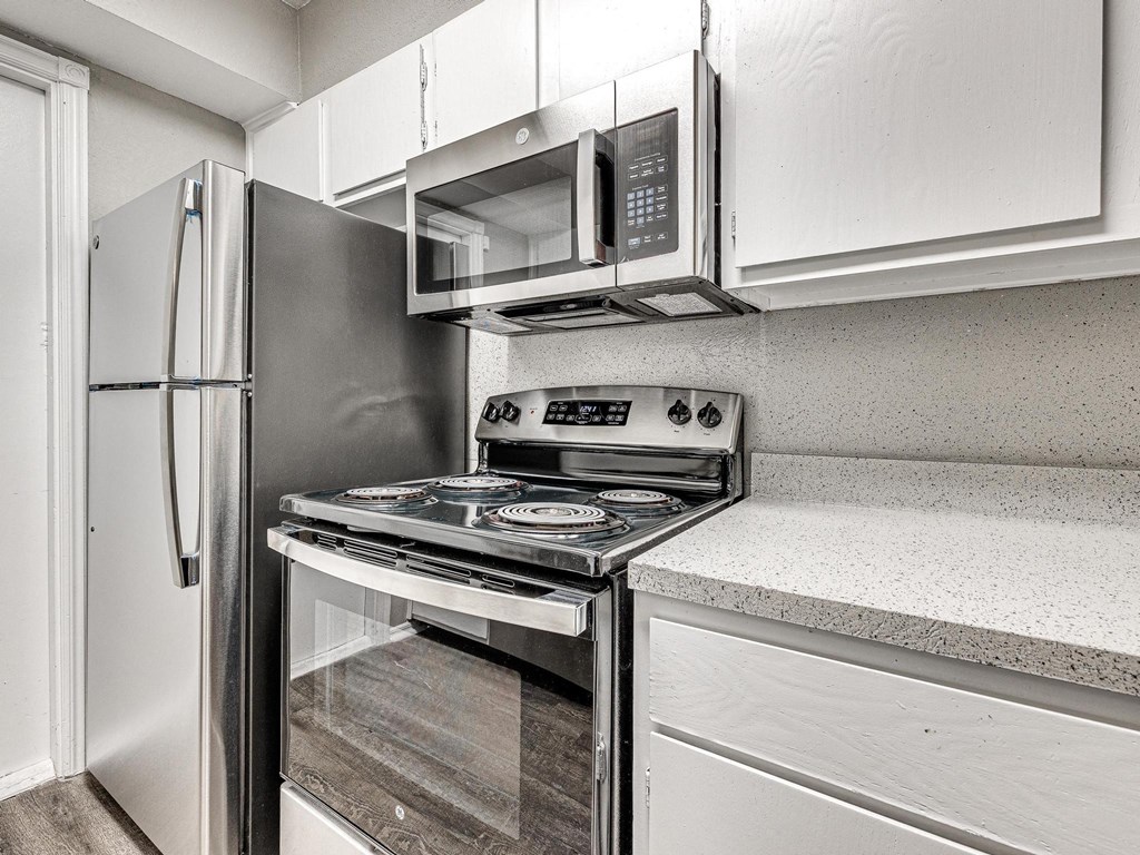 a kitchen with stainless steel appliances and white cabinets