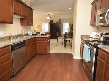 Kitchen looking into Living Room at Highlands of Grand Pointe Apartments in Lafayette, LA