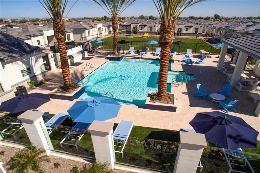 a swimming pool with umbrellas and chairs around it