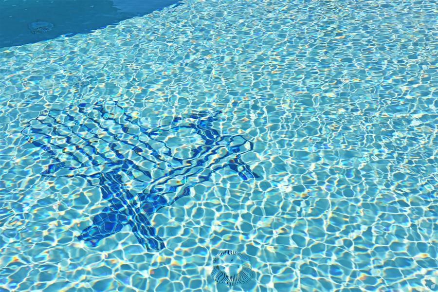 a reflection of a person in a swimming pool