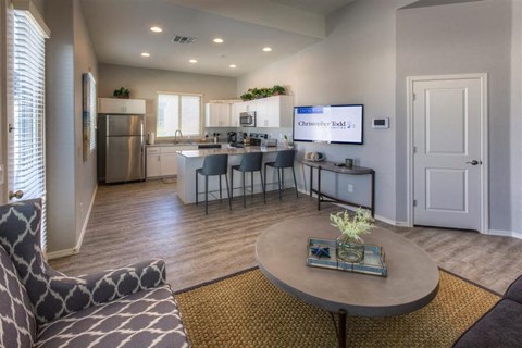 a living room with a kitchen and a table