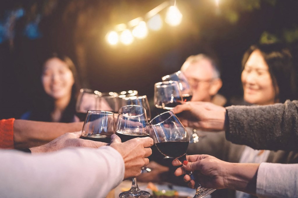 a group of people drinking wine at a table