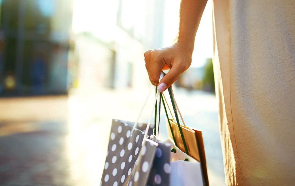 a woman holding shopping bags in her hand
