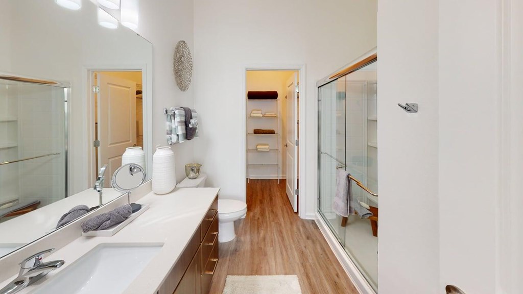 A bathroom with a white sink and a mirror.