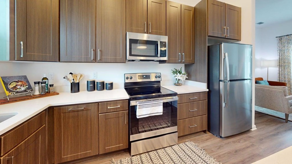A modern kitchen with wooden cabinets and stainless steel appliances.