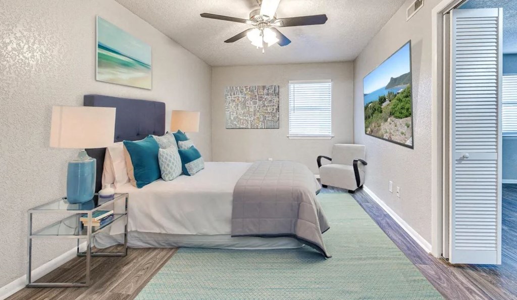 a bedroom with a bed and a ceiling fan