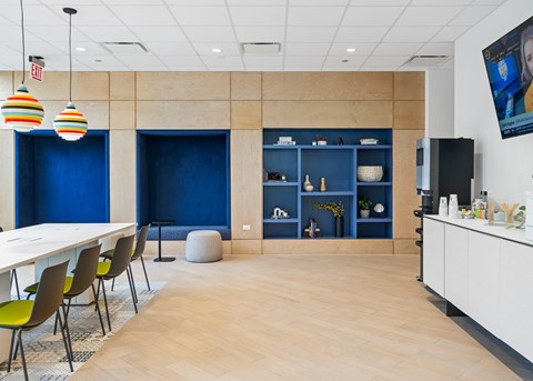 A conference room with a long table and chairs.