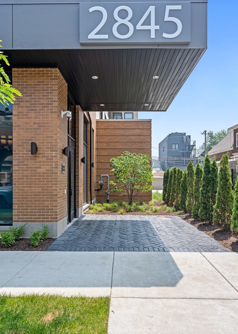 The image shows the front of a building with the number 2845 on it.