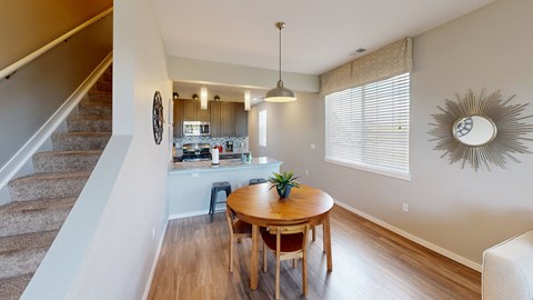 a dining room with a table and a kitchen