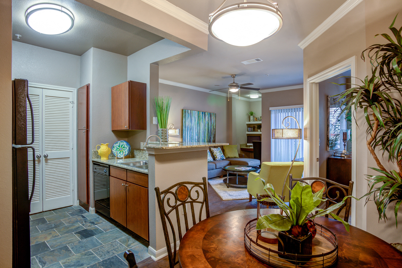 a kitchen and living room with a table and chairs