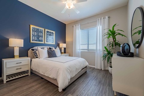 Modern bedroom with blue accent wall at Vistoria On Mountain View Apartments, Surprise, 85374