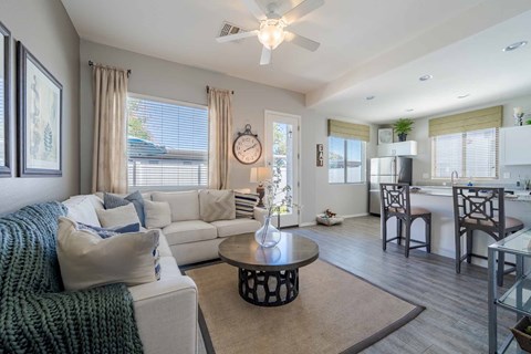 A living room with a white couch and a coffee table.