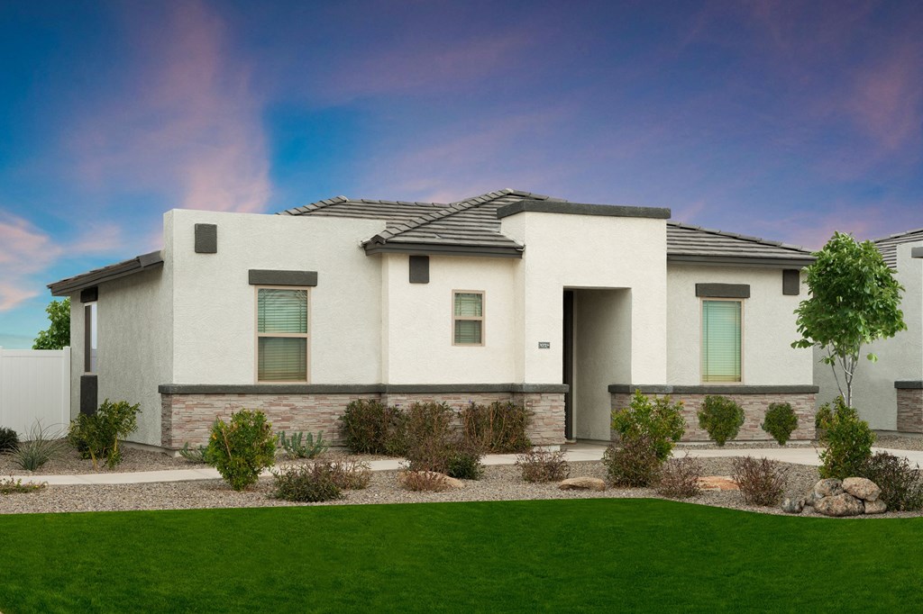 a white house with a front yard and grass