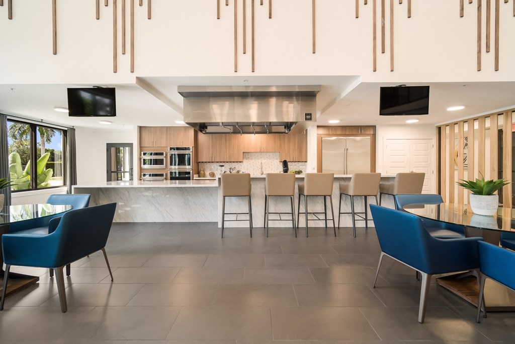 an open kitchen and dining area with a table and chairs Bedroom at Magnolia Square, Naples