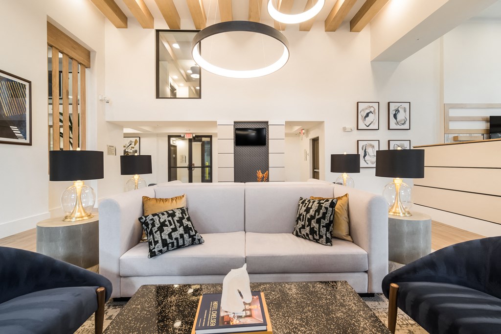 white couch with pillows and lighting above at Magnolia Square, Naples