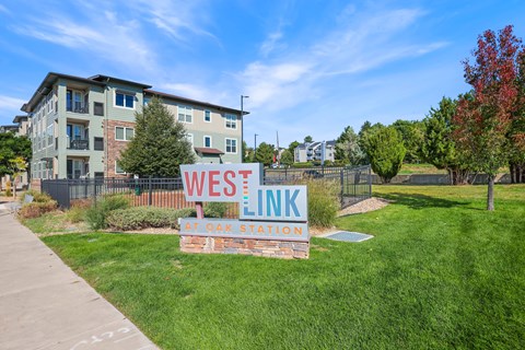A sign that says Westlink at Oak Station in front of a building.