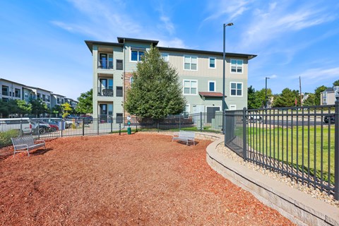 Apartment complex with a red mulched area in front.
