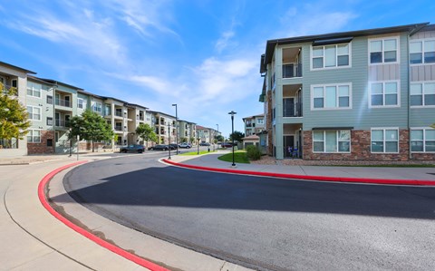 A street view of a residential area with apartment buildings on both sides.