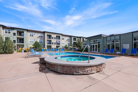 A swimming pool in front of apartment buildings.