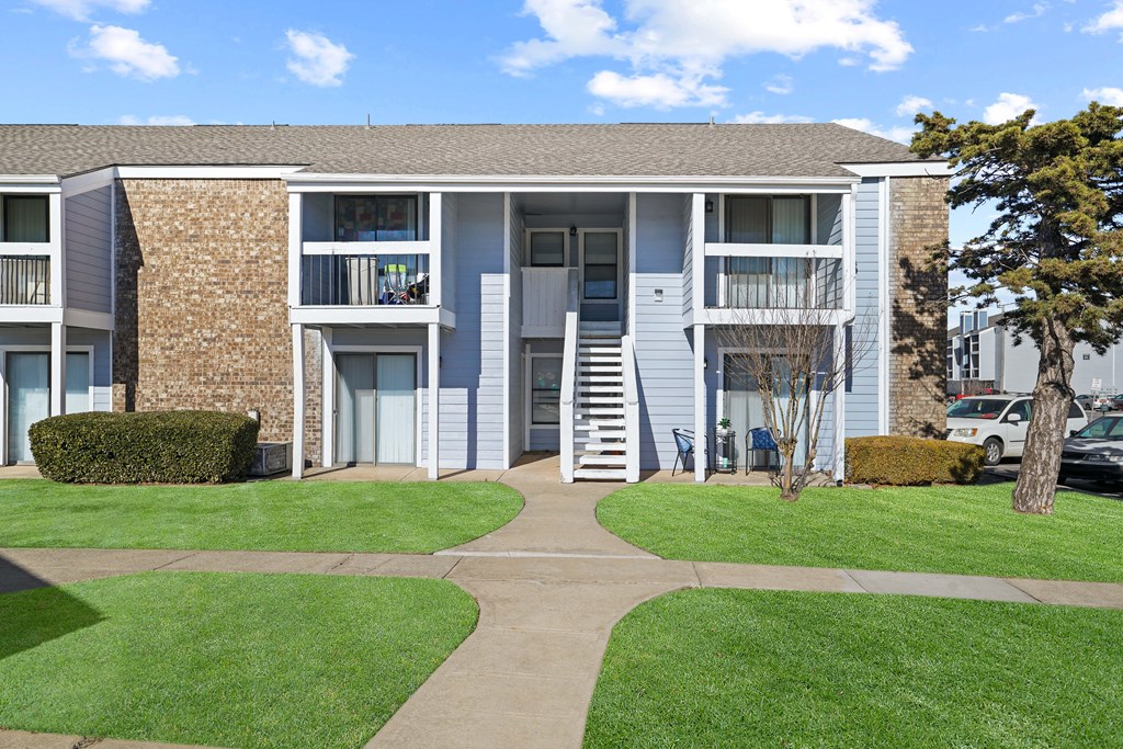 blue building and sky and green grass
