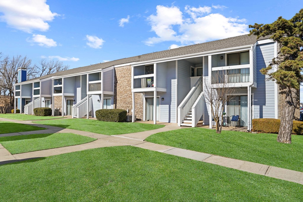 blue building and sky and green grass