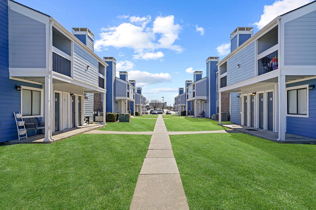 blue building and sky and green grass
