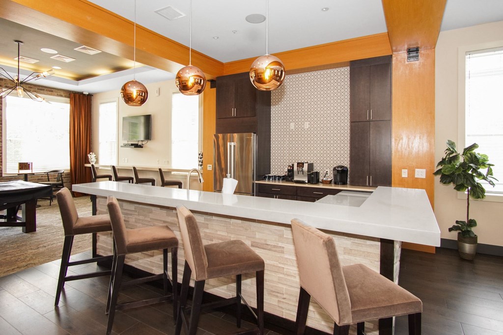 a kitchen with an island and a dining table at The Reserve at Riverdale, Riverdale, 07457