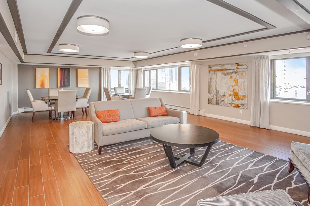a living room and dining room with couches and a table at 10 West Apartments, Long Beach, NY