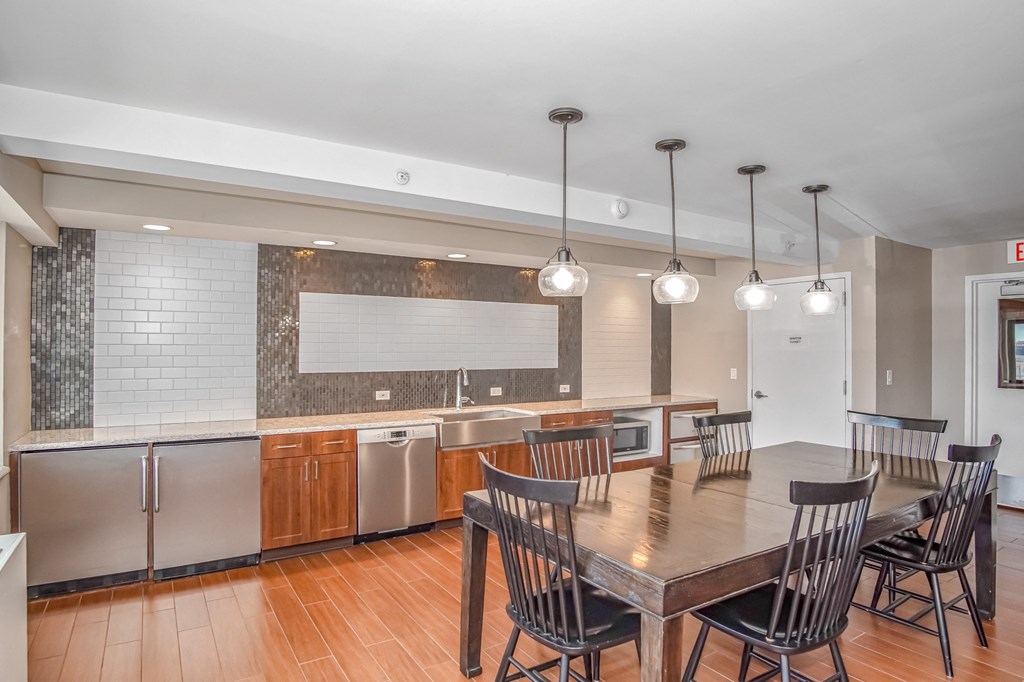a kitchen and dining room with a table and chairs at 10 West Apartments, Long Beach