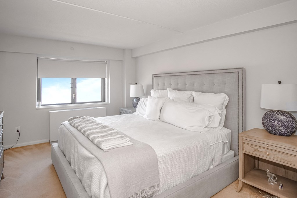 a bedroom with a large bed and a window at 10 West Apartments, Long Beach