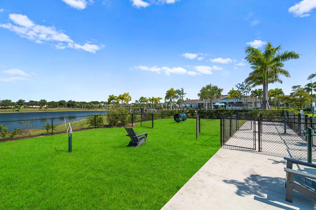 a dog park with a chain link fence and benches on the grass at Artesia at Lakewood Ranch Apartments, Bradenton, 34211