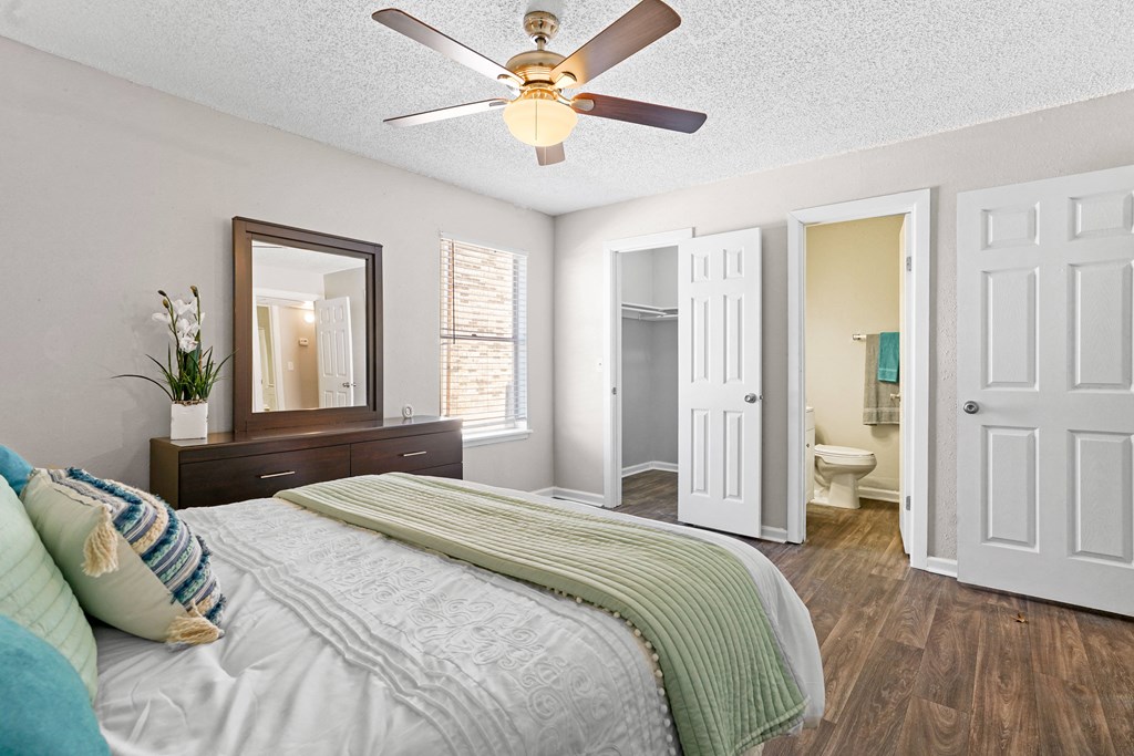 a bedroom with a large bed and a ceiling fan at Diamond  Trail Apartments, Oklahoma City