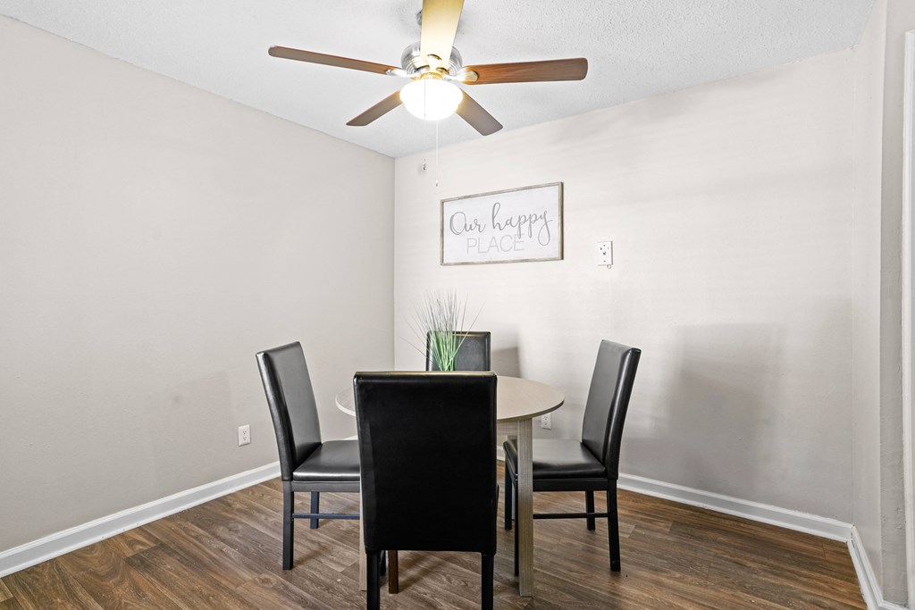 a dining room with a table and chairs and a ceiling fan at Diamond  Trail Apartments, Oklahoma City