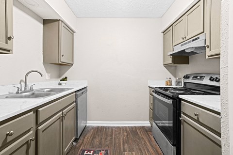 a kitchen with stainless steel appliances and white cabinets