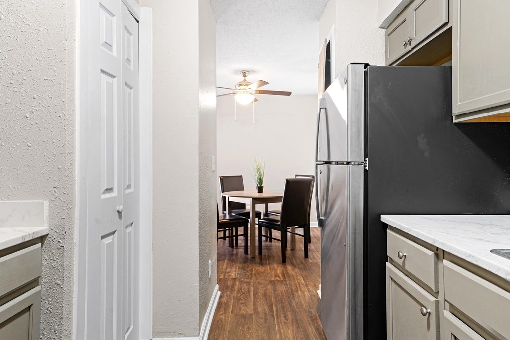 our apartments offer a kitchen and dining room with a black refrigerator at Diamond  Trail Apartments, Oklahoma City, OK, 73112