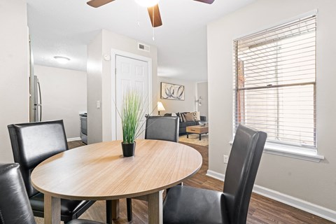 a dining room with a wooden table and black leather chairs at Diamond  Trail Apartments, Oklahoma