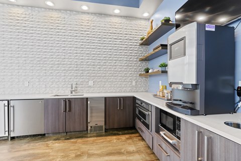 a kitchen with white countertops and gray cabinets at WestLink at Oak Station, Lakewood, 80215