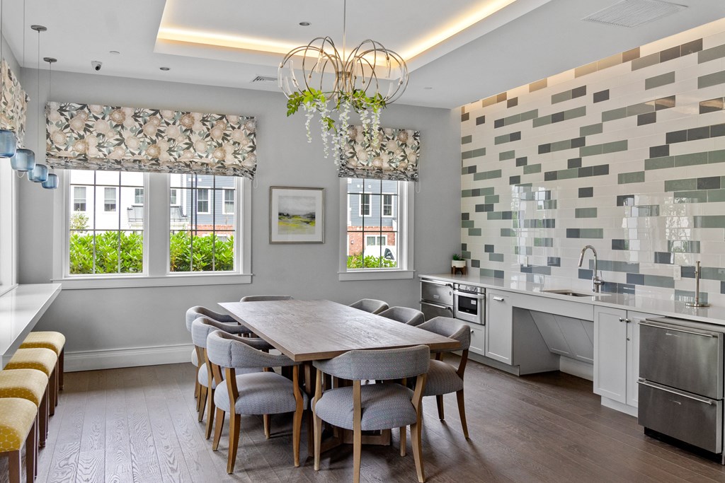 a kitchen with a table and chairs in a 555 waverly unit at Cirrus Apartments, Massachusetts