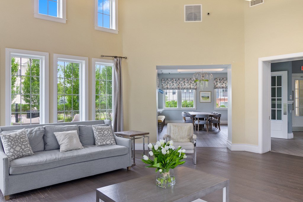 a living room filled with furniture and a large window at Cirrus Apartments, Ashland, MA, 01721