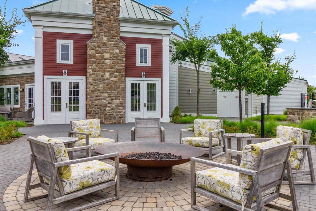 a patio with chairs and a fire pit at Cirrus Apartments, Ashland, 01721