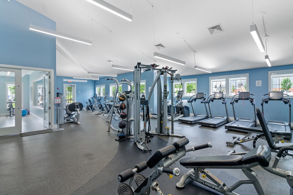 a gym with cardio equipment and weights at Cirrus Apartments, Massachusetts, 01721
