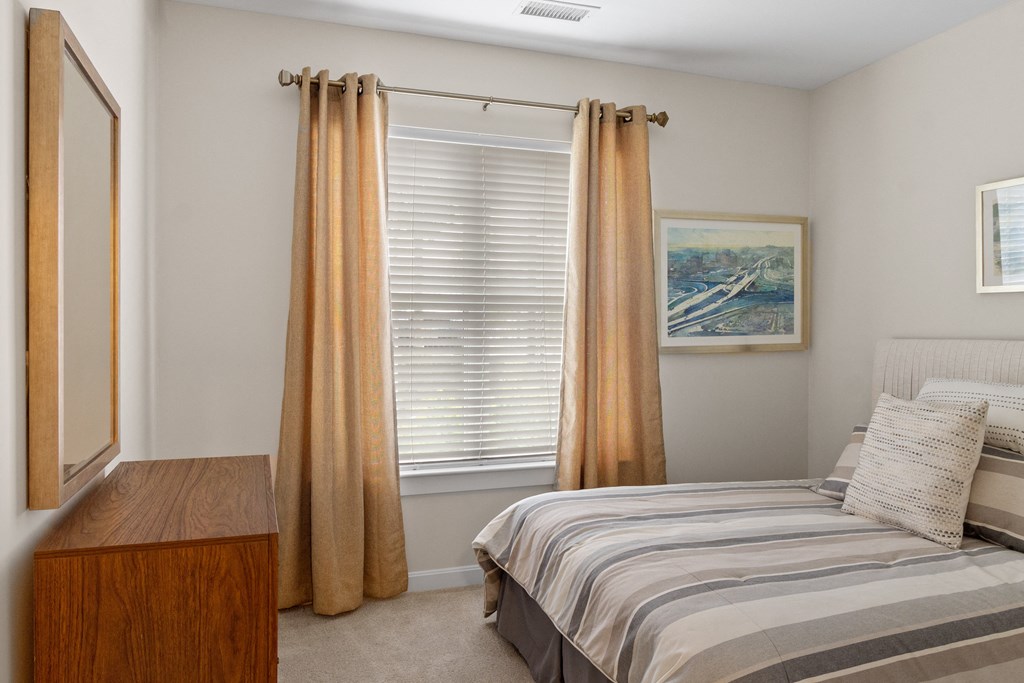 a bedroom with a bed and a dresser at Cirrus Apartments, Massachusetts