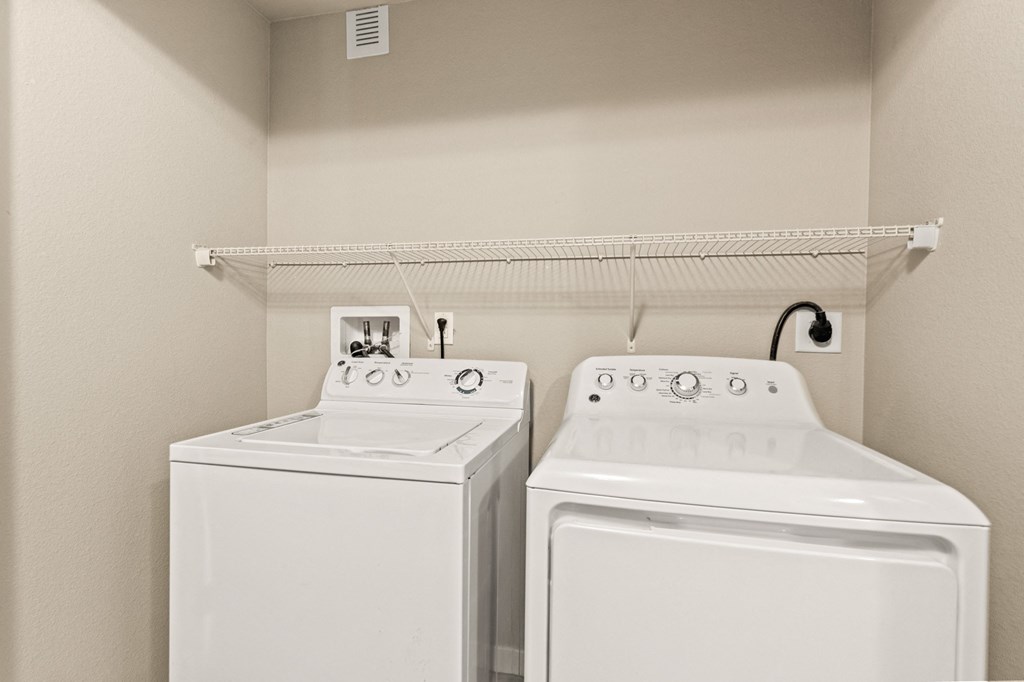 a washer and dryer in a laundry room at Black Feather Apartment Homes, Colorado, 80104