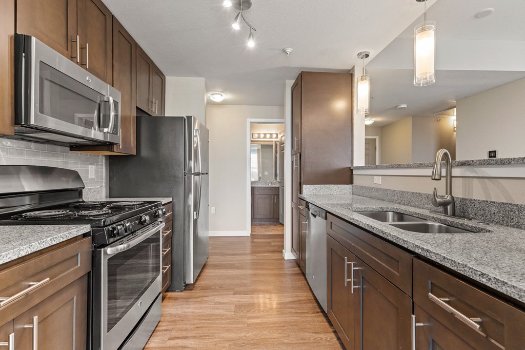 a kitchen with stainless steel appliances and granite countertops at Black Feather Apartment Homes, Colorado, 80104