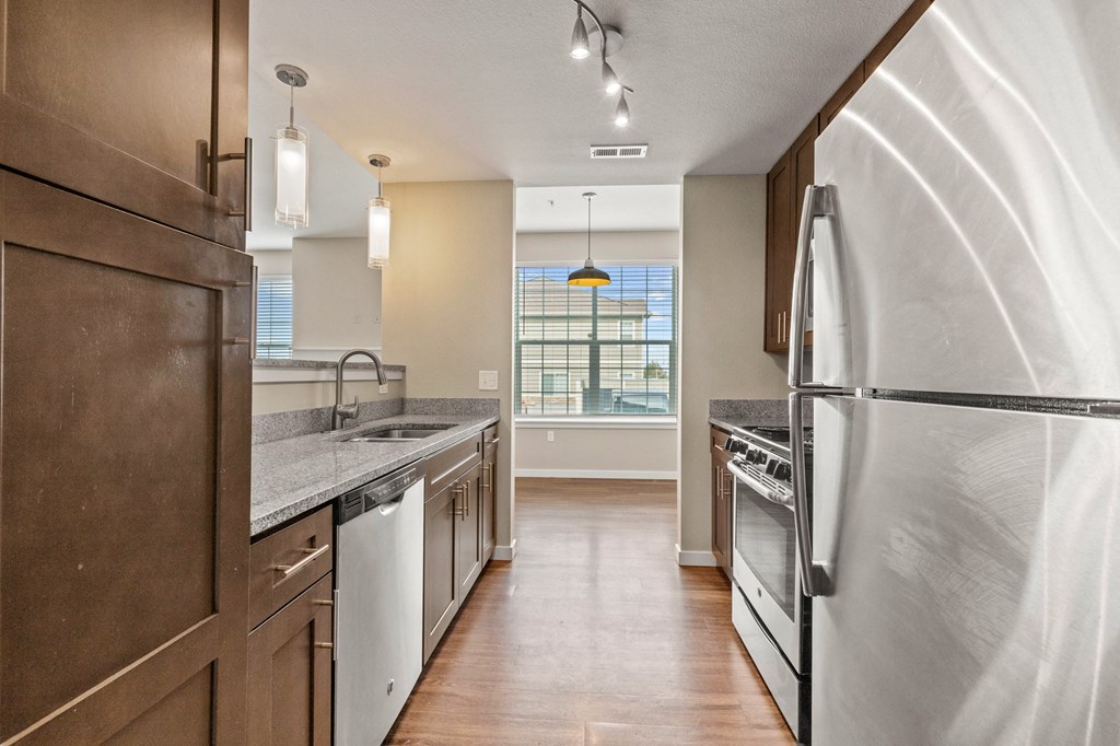 a kitchen with white appliances  at Black Feather Apartment Homes, Castle Rock, Colorado