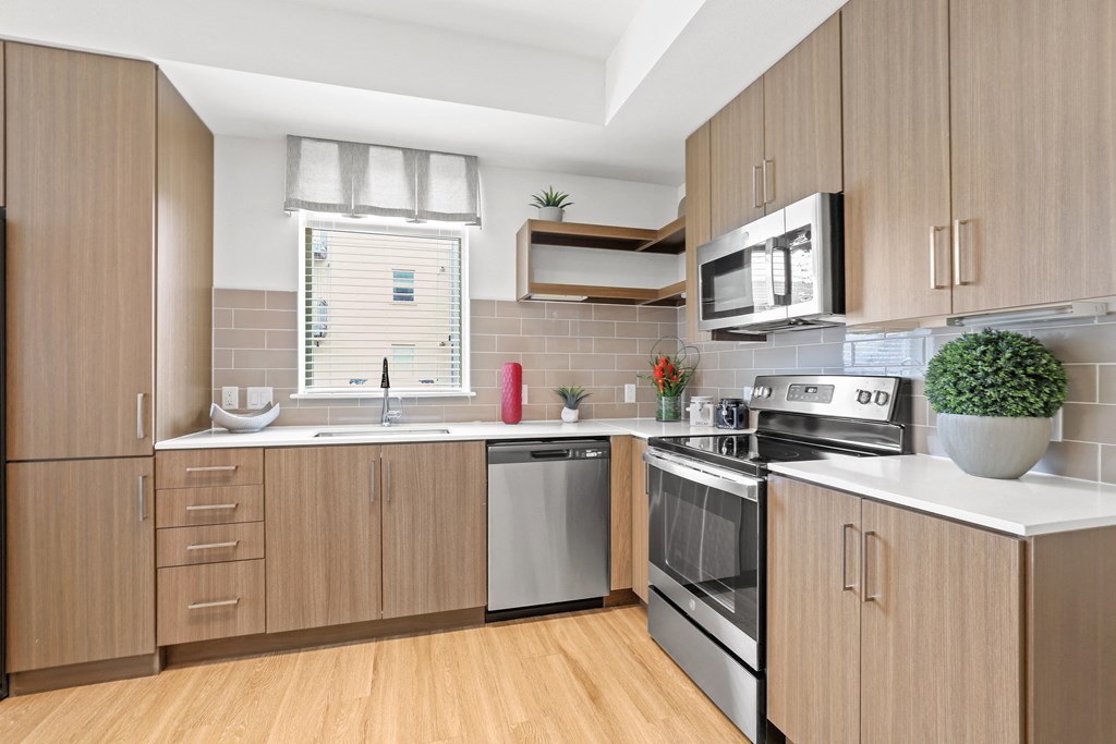 a kitchen with wooden cabinets and white countertops