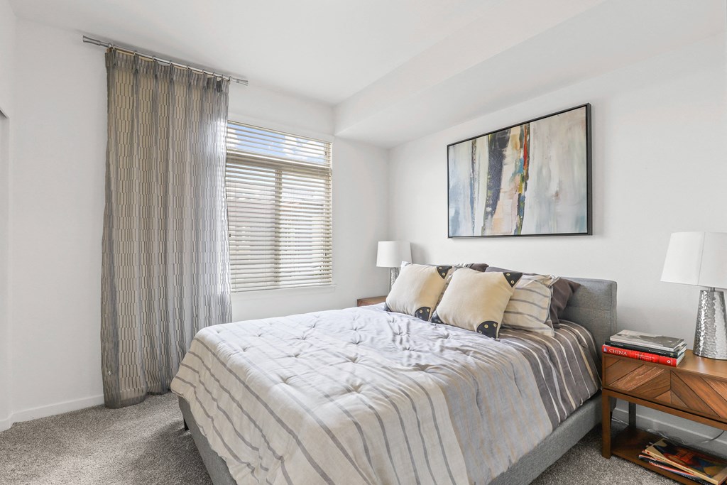 a bedroom with a large bed and a large window