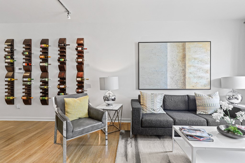 a living room filled with furniture and a large painting on a wall