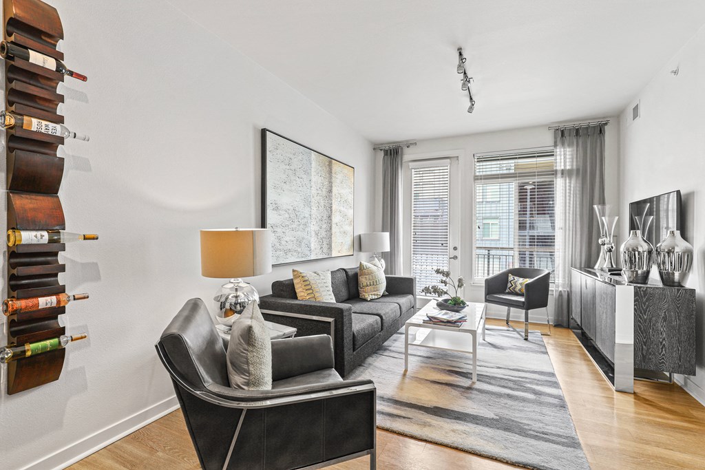 a living room with white walls and hardwood floors