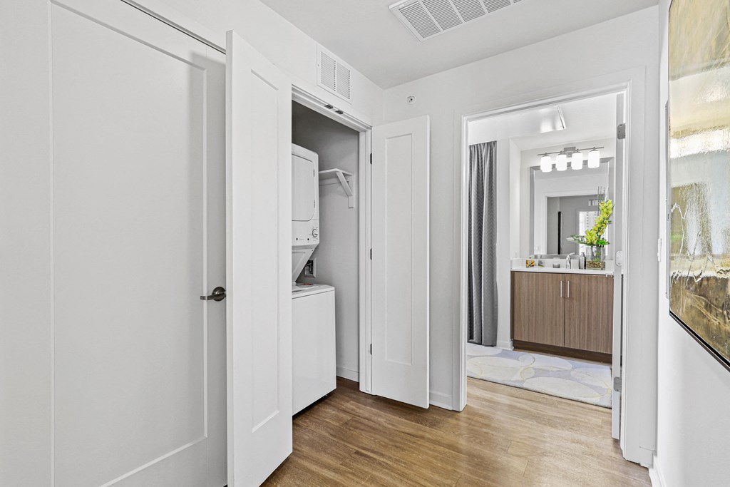 a bedroom with a medium hardwood floor and white walls